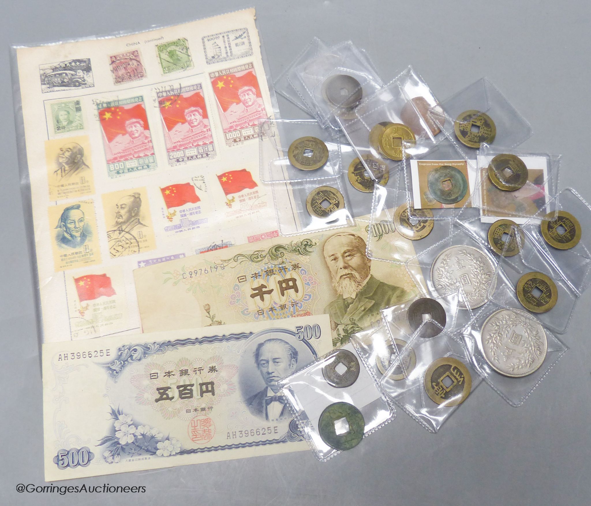 A collection of Chinese coins, stamps and two Japanese banknotes